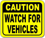 Caution watch for vehicles Bright yellow metal outdoor sign