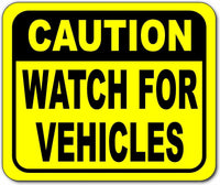 Caution watch for vehicles Bright yellow metal outdoor sign
